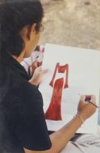 A student participating in an art competition, is seen working on an art piece