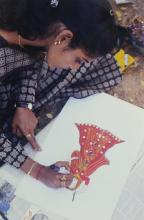 A student participating in an art competition at Saarang 2000 is seen working on an art piece