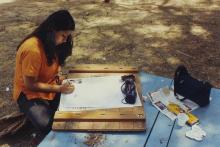 A student participating in an art competition at Saarang 2000 is seen working on an art piece