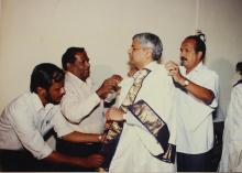 Dr. Gururaj Deshpande is assisted with his convocation robe, Special Convocation (2001)