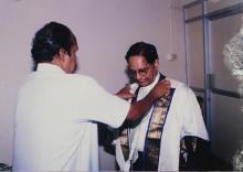 Dr. K. Anji Reddy is assisted with his convocation robes at the 39th Convocation, 2002
